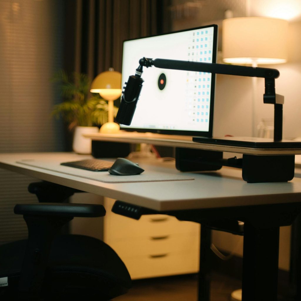 A cozy home office featuring an ergonomic chair, computer setup, and ambient lighting for a productive environment.