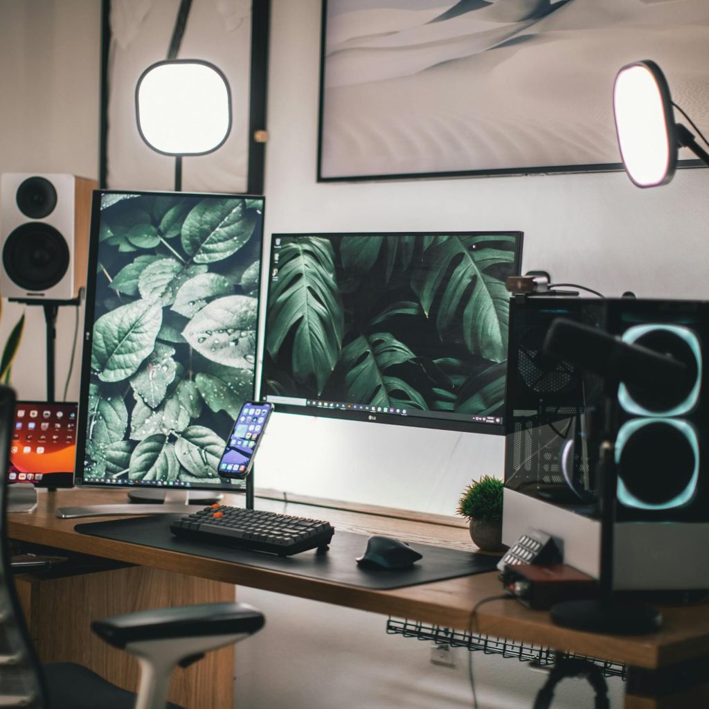 Stylish gaming and streaming setup with dual monitors, PC, and accessories.